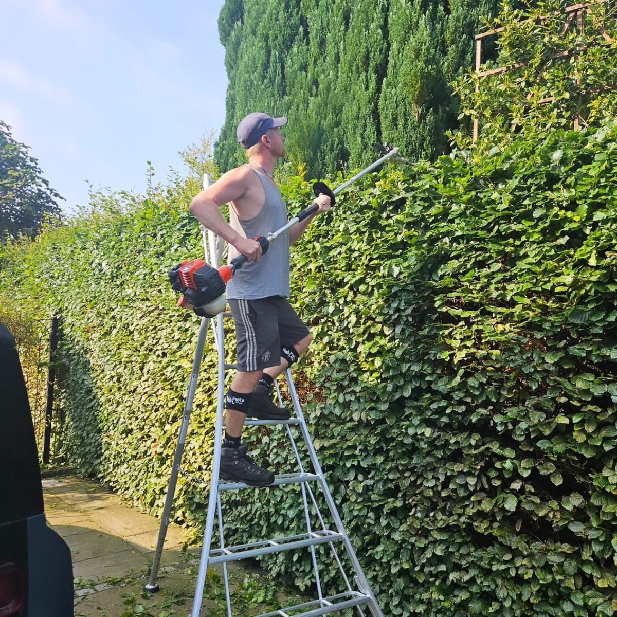 Gardener trimming hedge in Macclesfield
